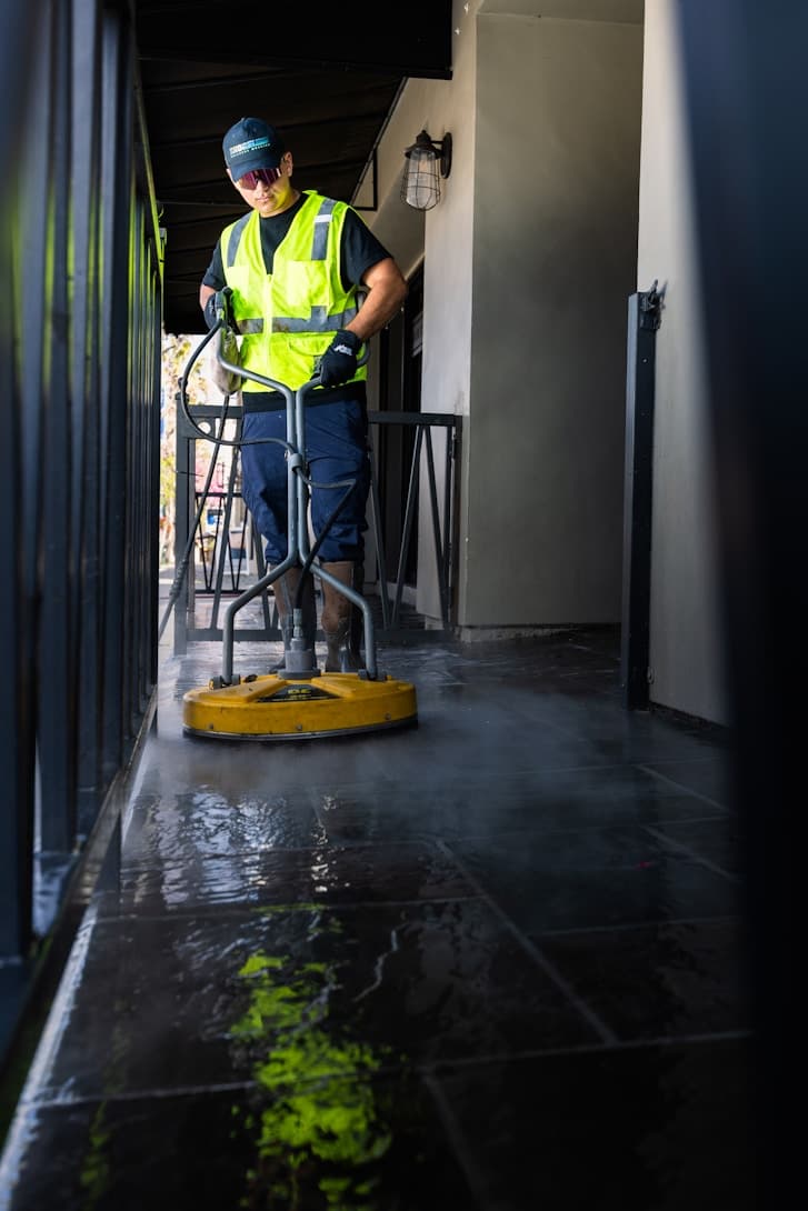 AIK clean-up team using a floor scrubber post-handover